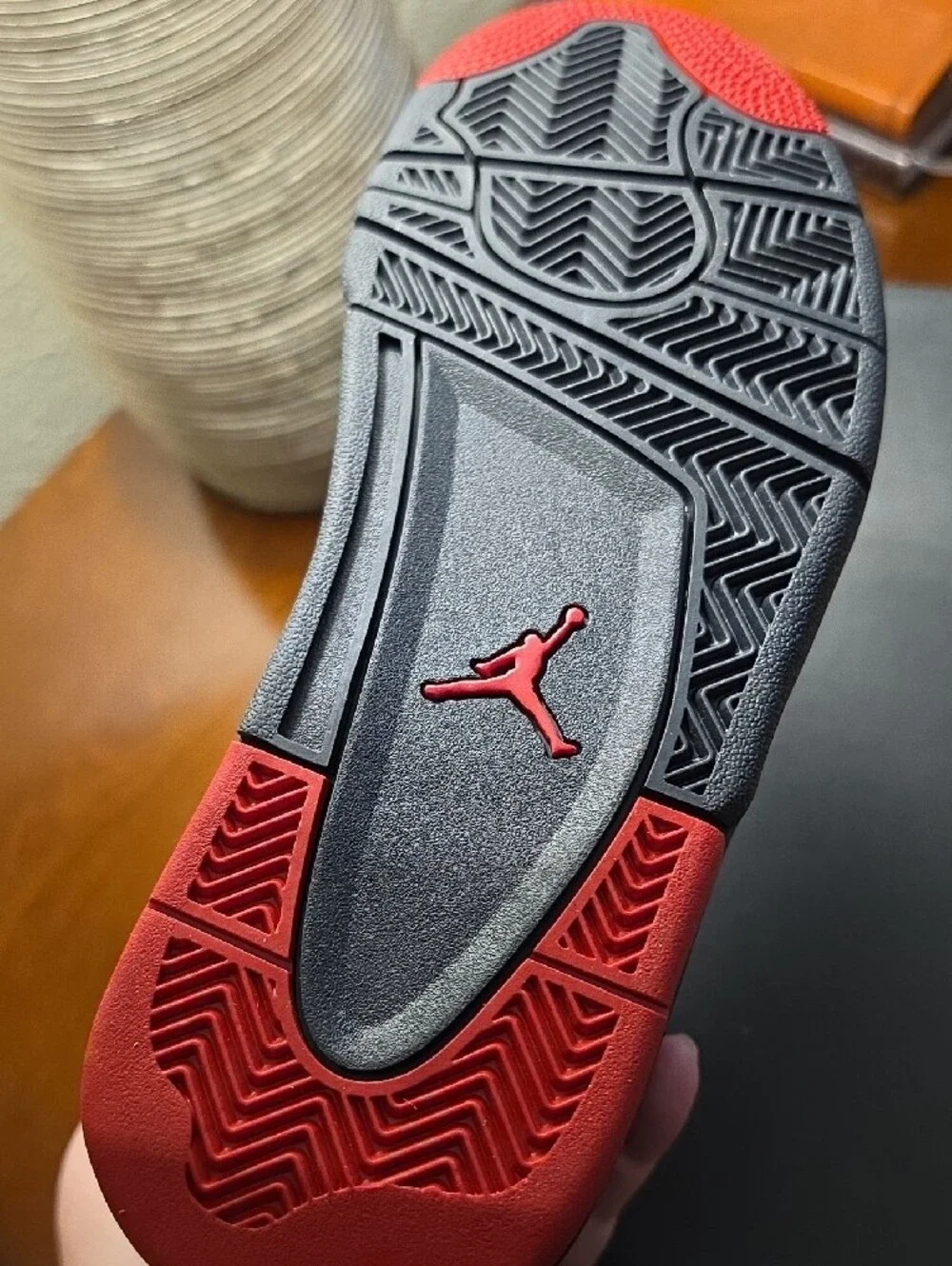 Air Jordan 4 RM Youth Athletic Shoe in Black with Red Accents 7Y